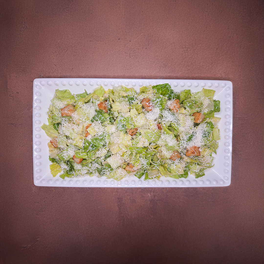 Chez Panise Caesar salad on a white rectangular plate