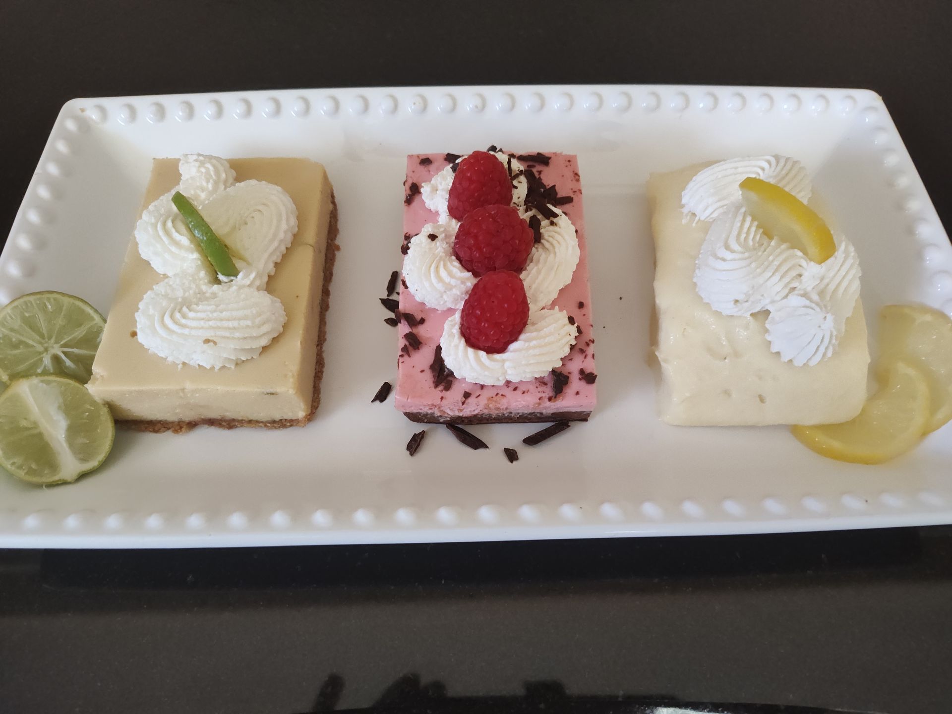 Chez Panise 3 desserts on a plate, key lime square, raspberry square, and lemon square