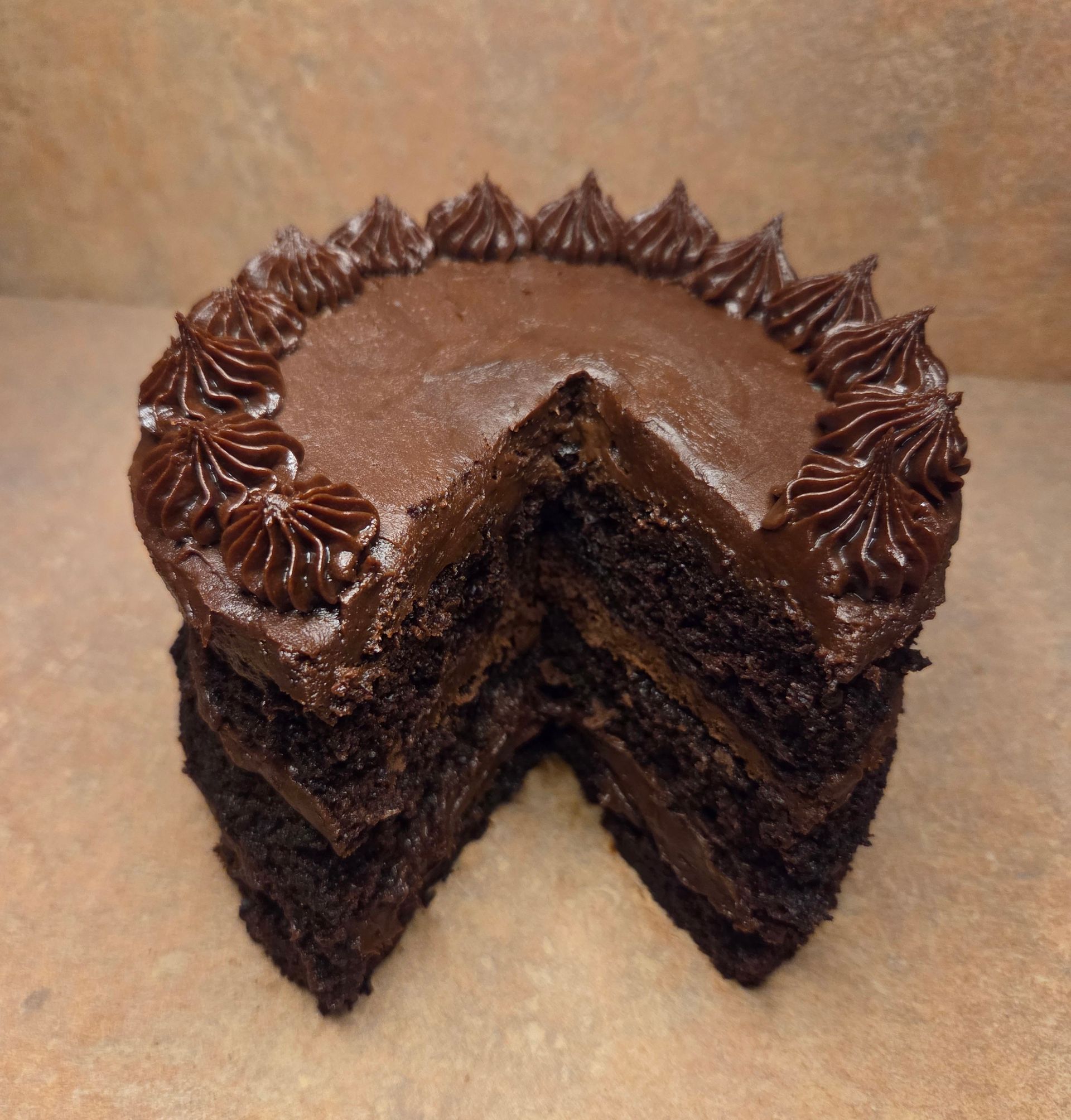 Chez Panise Chocolate Cake with a slice taken out