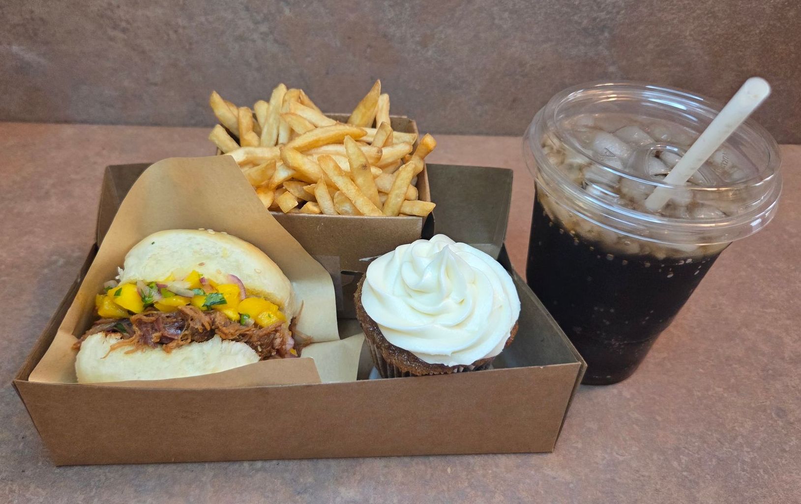 Chez Panise Number 1 combo with a slider, fries, drink, and cupcake