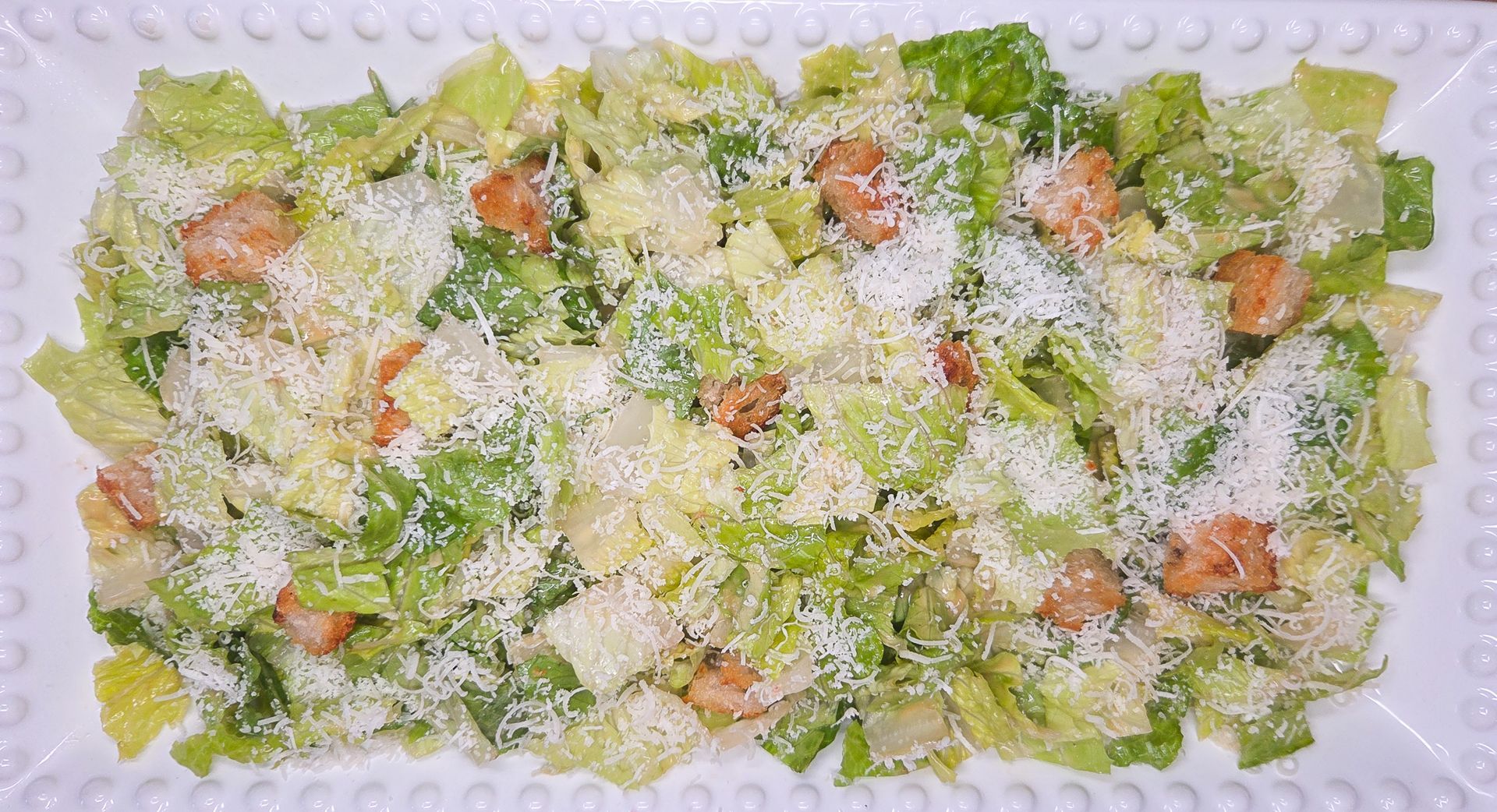 Chez Panise Caesar salad on a white rectangular plate