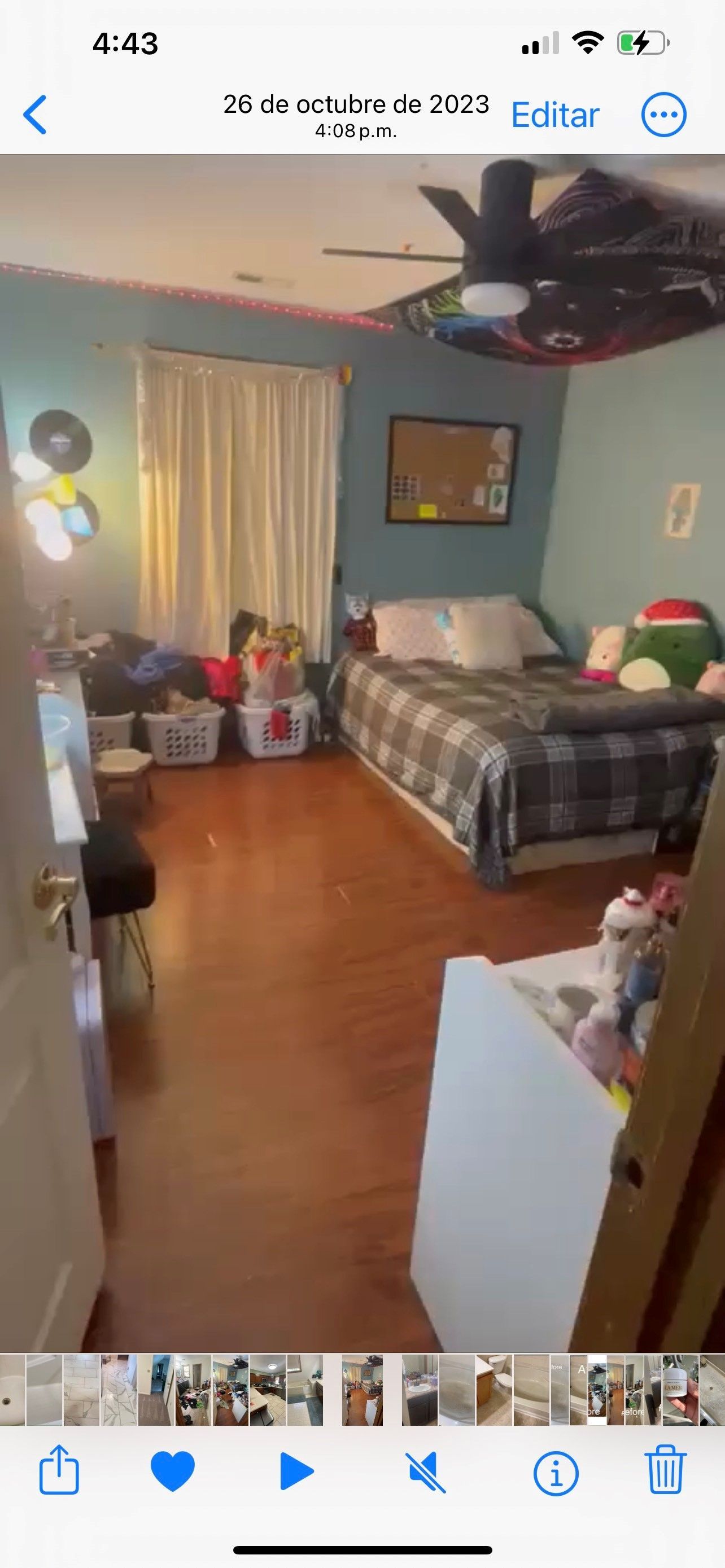 A bedroom with two beds and a ceiling fan.