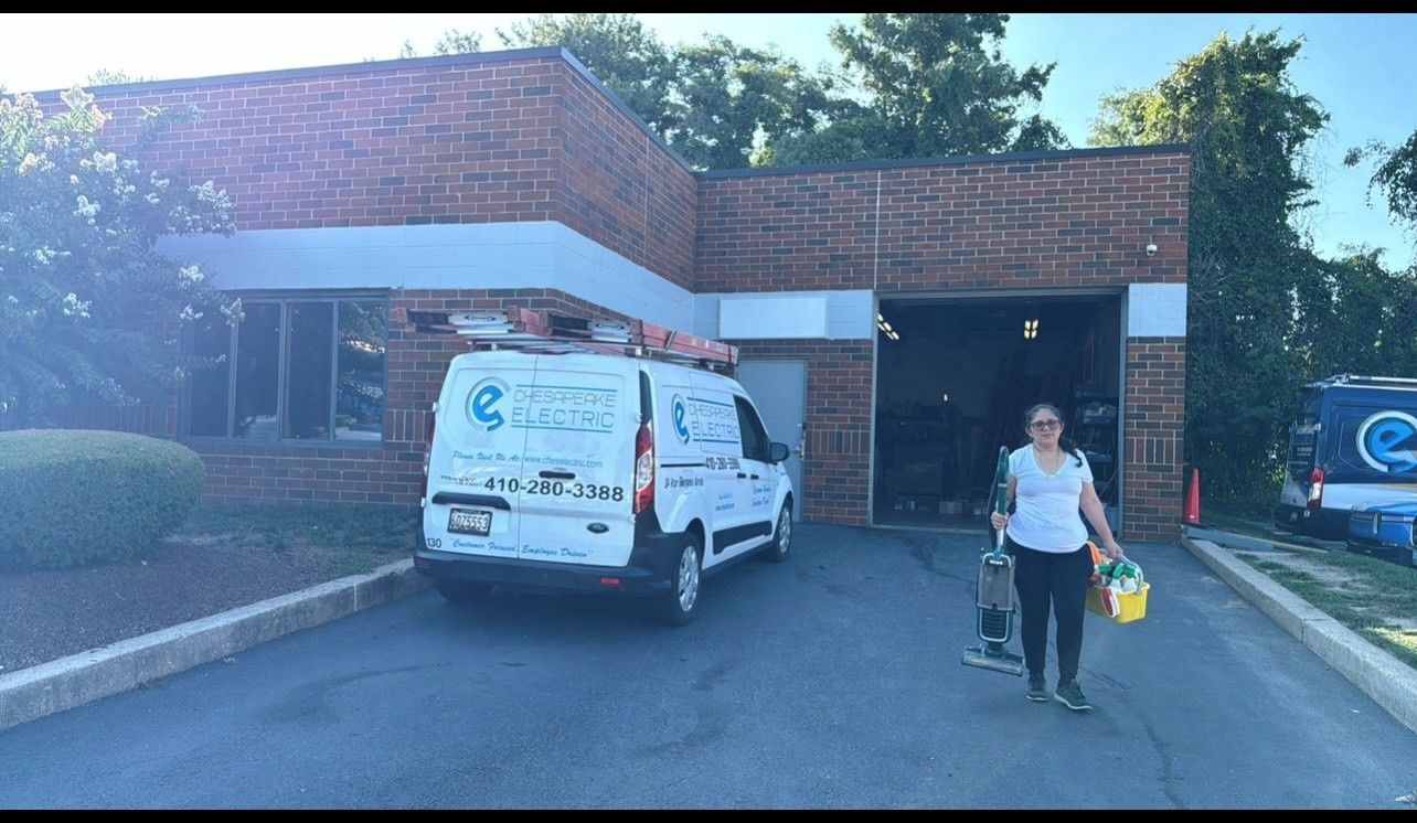A group of people are standing outside of a brick building.