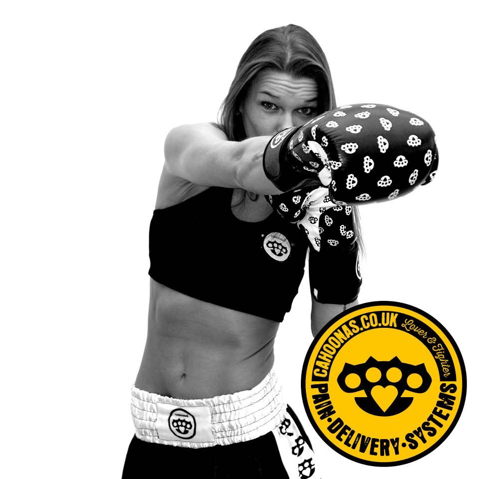 this image features a black and white photo of a female boxer throwing a straight jab directly at camera.