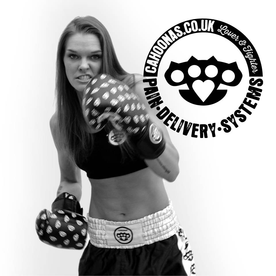 female boxer snarls at camera wearing boxing gloves