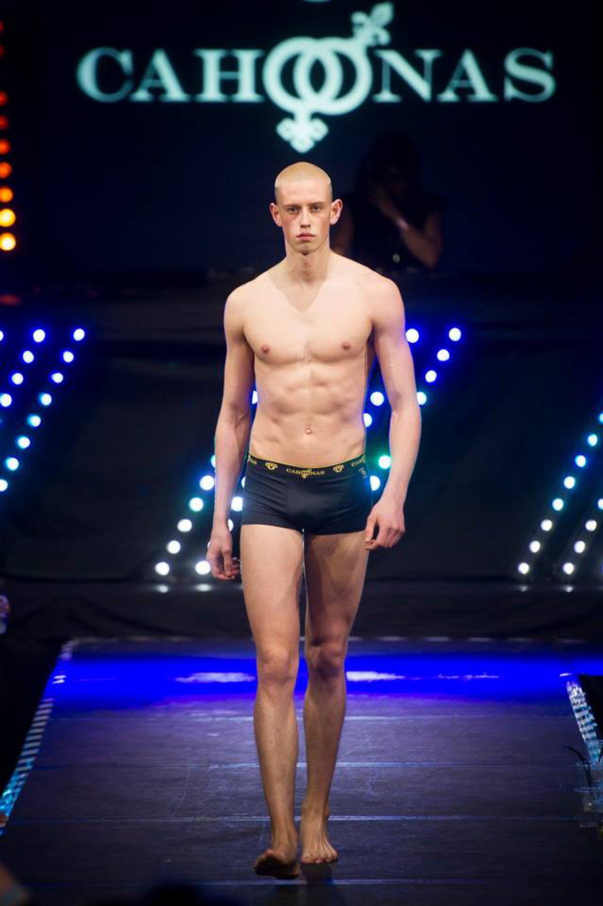 Toned sexy male model walks towards camera wearing only Cahoonas luxury male underwear.