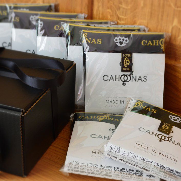 Picture features a selection box full of luxurious male underwear on a wooden bench in a display box