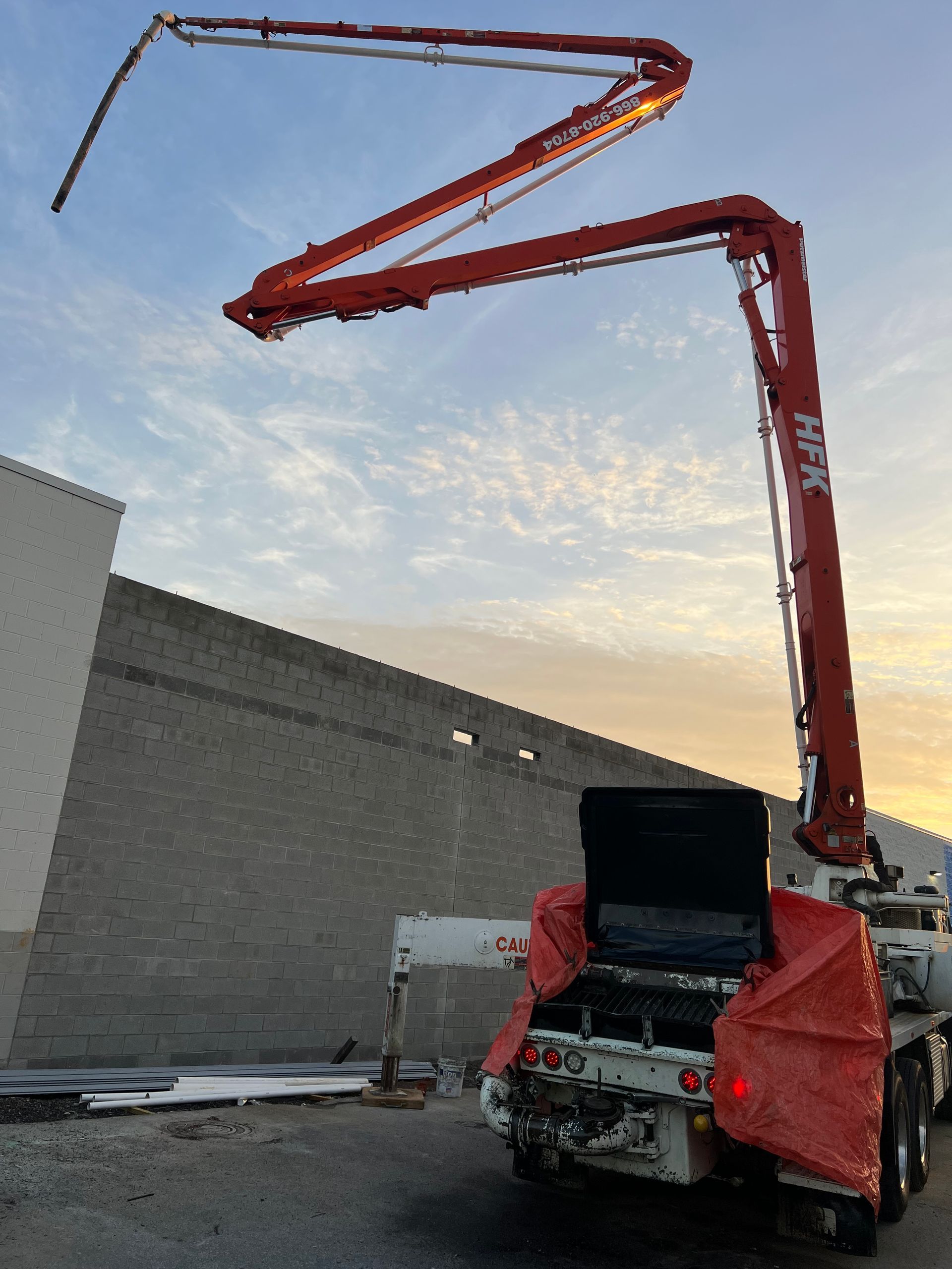A concrete pump is attached to the back of a truck