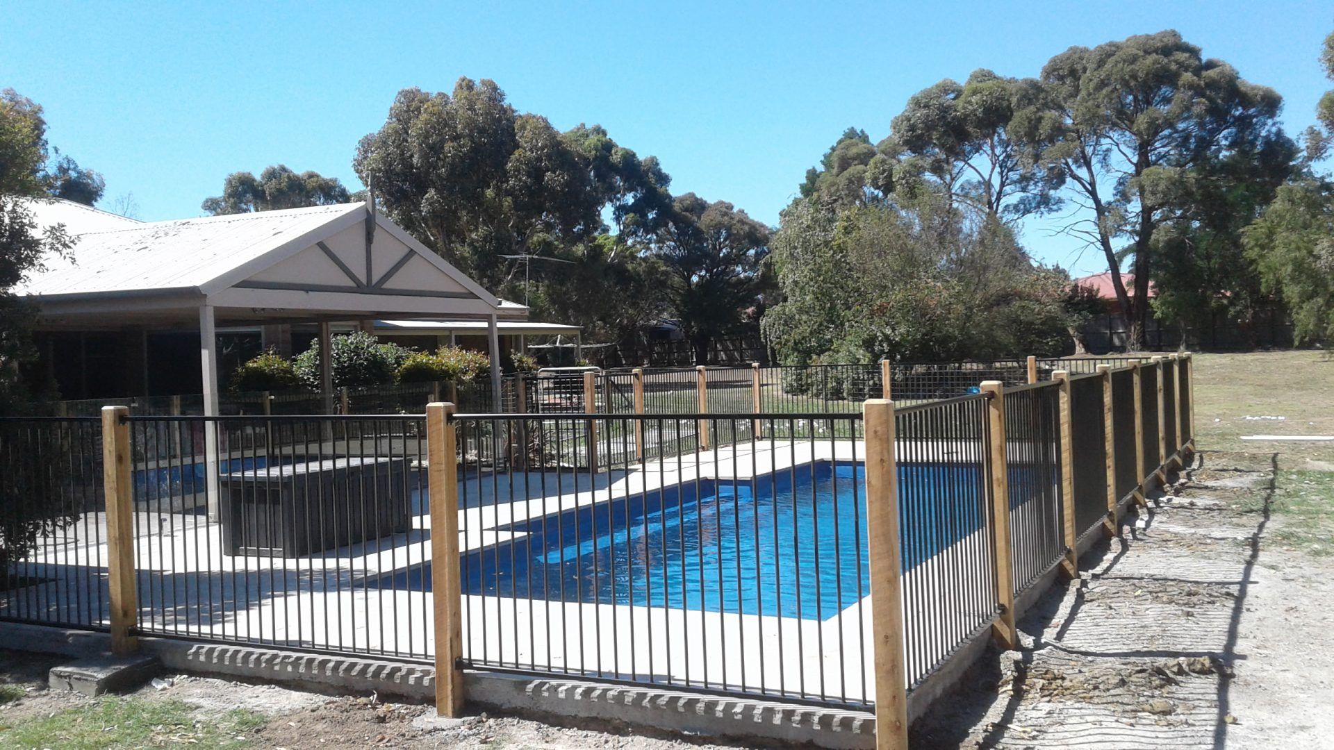 A Wooden Retaning Wall next to a Canal — Tuff Fencing in Caboolture, QLD