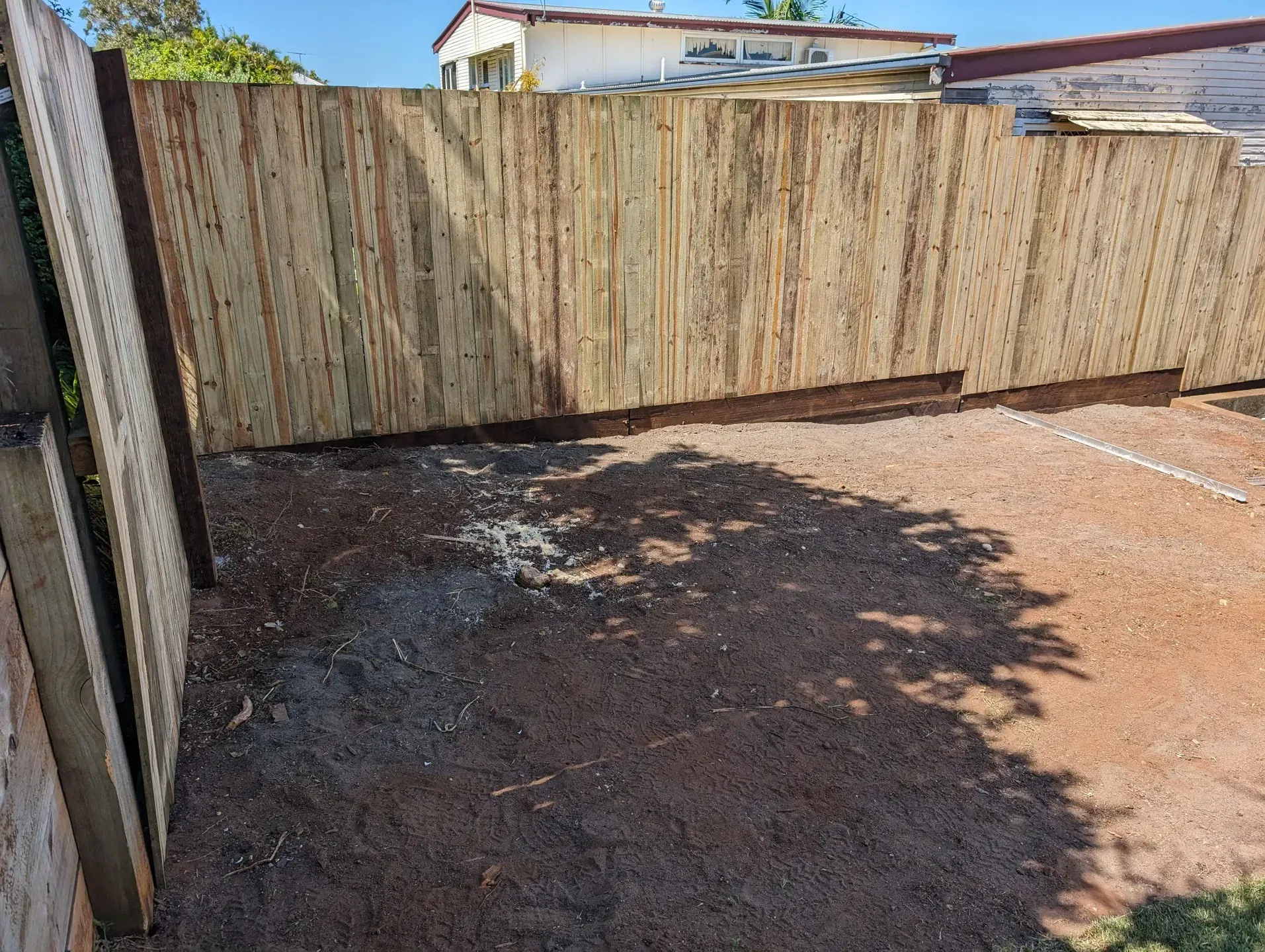 A Wooden Slat Fence with Red Gravel Backyard — Tuff Fencing in Caboolture, QLD