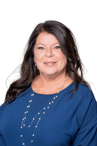 Woman in blue top wearing a silver necklace, smiling against a white background