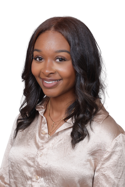 Smiling woman with wavy dark hair wearing a light satin blouse on a white background