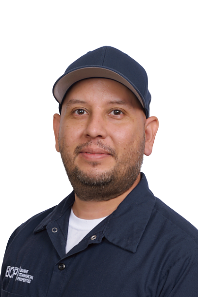 Portrait of a man in a navy cap and work shirt against a white background