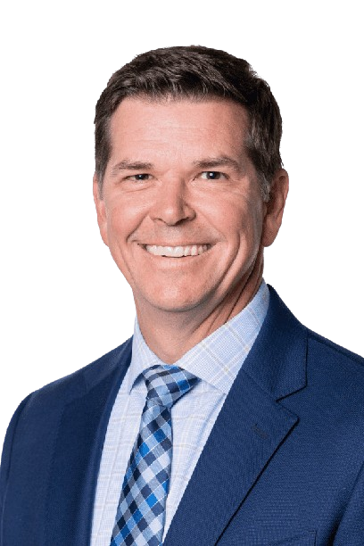 Smiling man in a blue suit and patterned tie on a white background