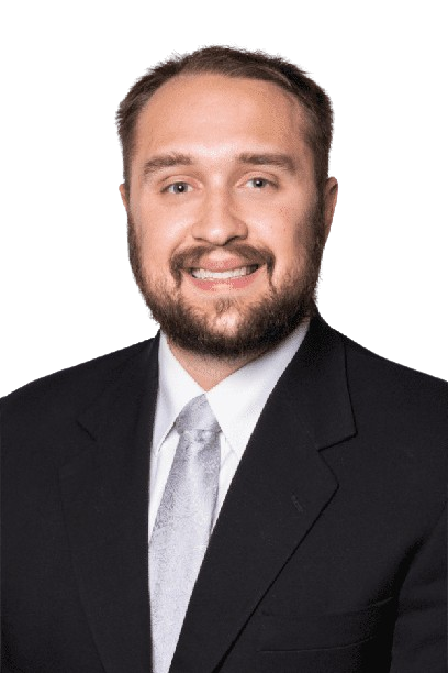 Portrait of a smiling man in a black suit, white shirt, and light gray tie on a white background