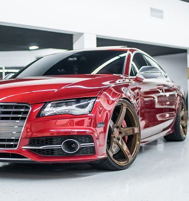 A red sports car with bronze wheels| American Five Star Auto Repair & Transmission