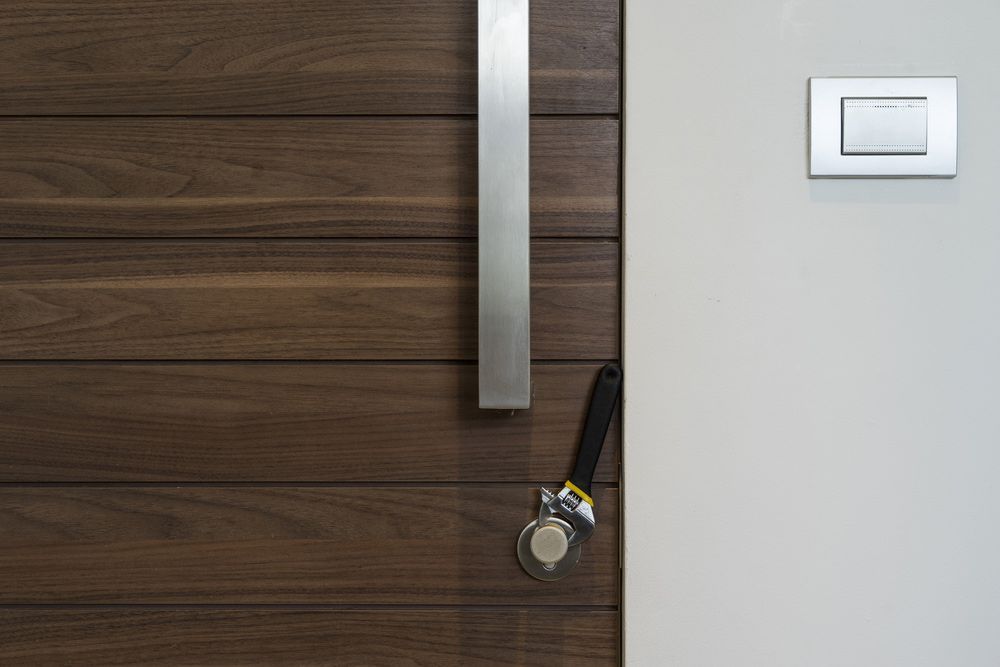 A Close Up of a Wooden Door With a Stainless Steel Handle — The Skeleton Key Locksmiths & Security in West Tamworth, NSW
