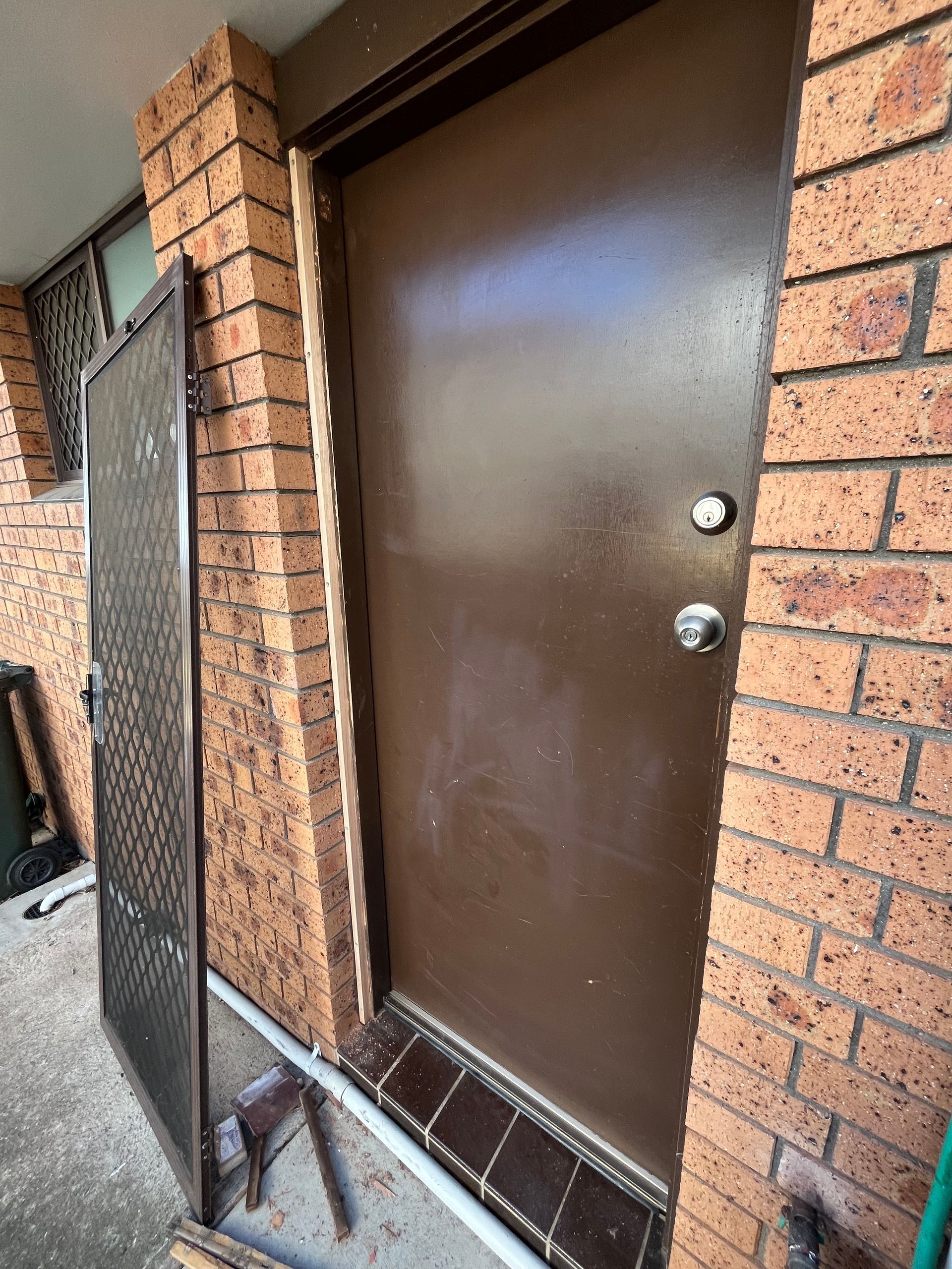 Brown Door With Screen Door Detatched — The Skeleton Key Locksmiths & Security in West Tamworth, NSW