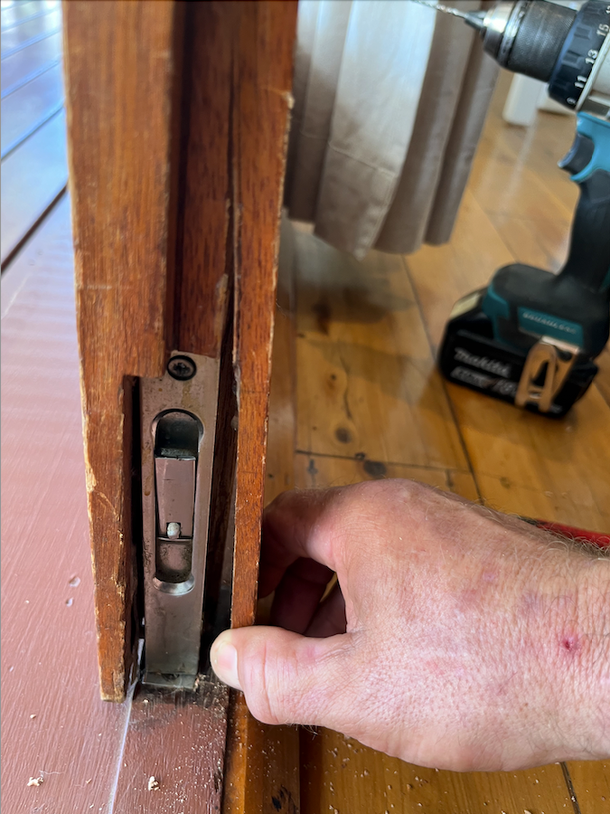 A Person is Fixing a Door Lock  — The Skeleton Key Locksmiths & Security in West Tamworth, NSW