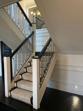 Expert interior painting and decorating by Kirkdec Painting & Decorating. Featuring panelling and dark wood stained handrail.