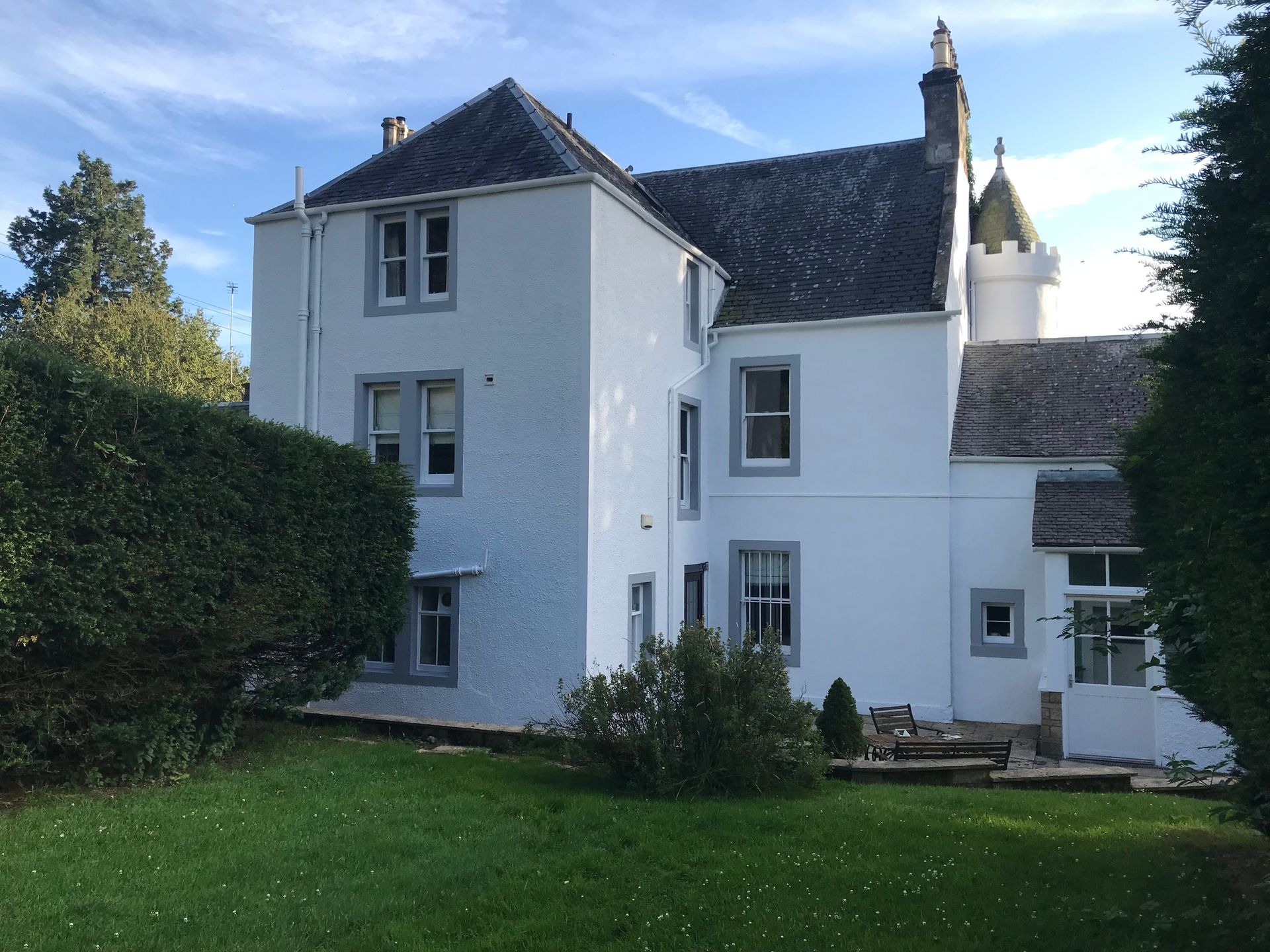 Professional exterior masonry painting on a large three-story white residential home in Lanarkshire, completed by award winning firm Kirkdec Painting & Decorating