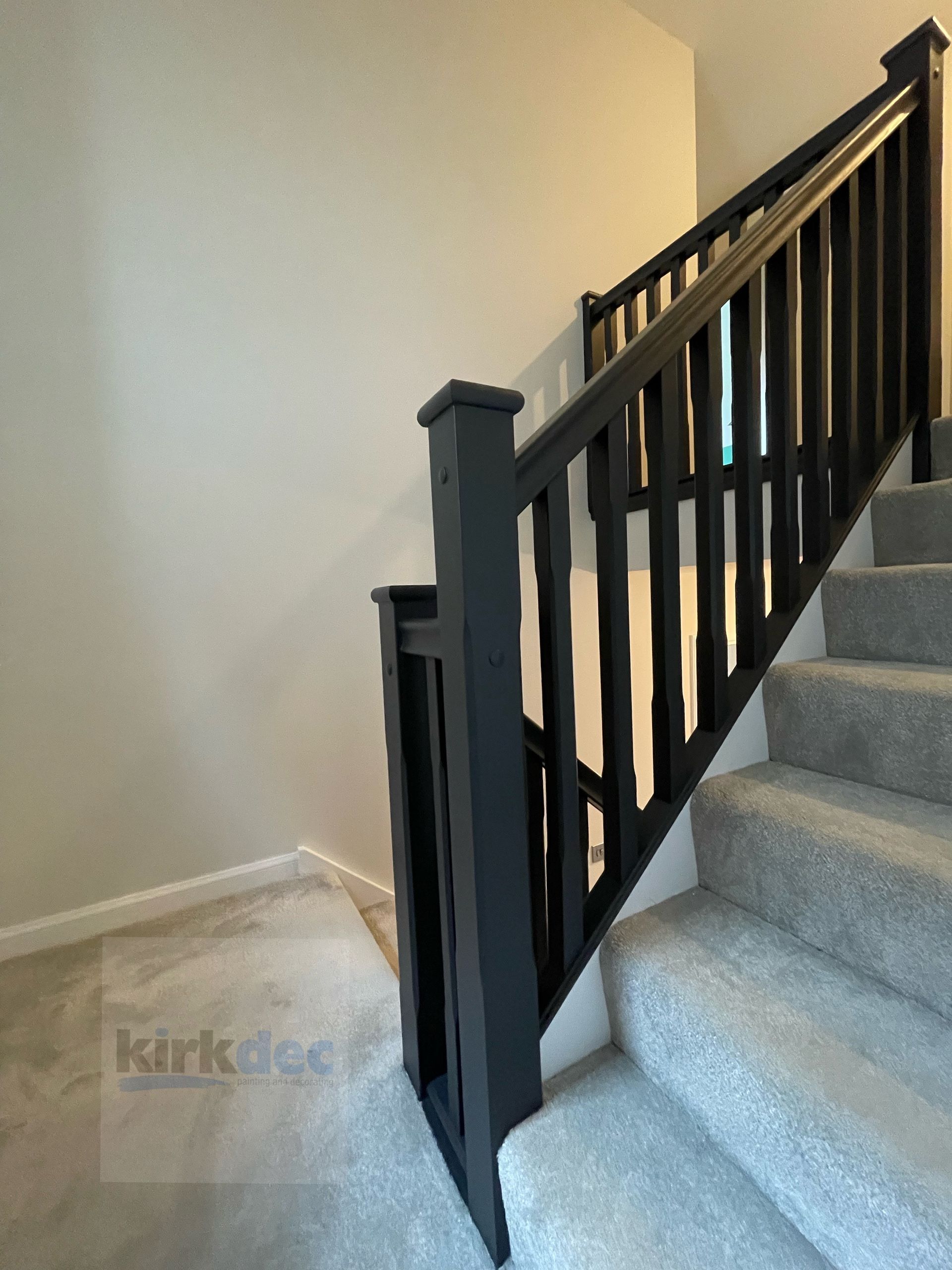Professional staircase and woodwork painting by Kirkdec, featuring a clean satin finish on handrails and spindles