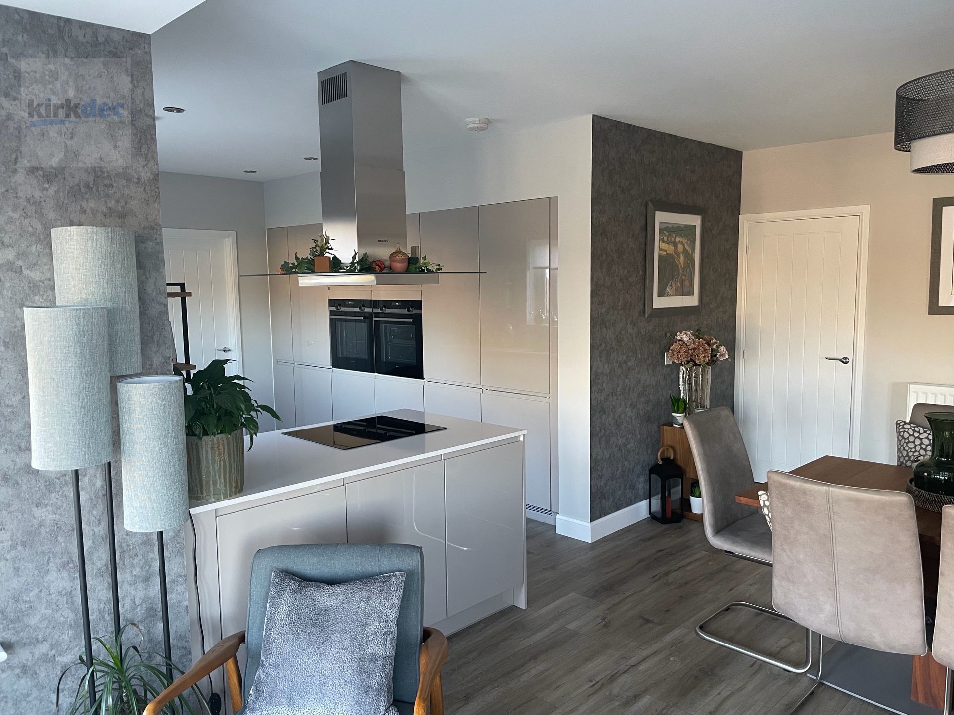 Modern open-plan kitchen dining area painting by Kirkdec, using durable and sustainable finishes, in South Lanarkshire