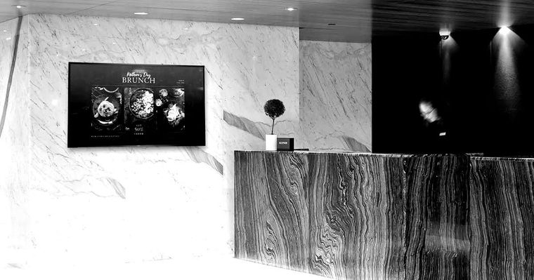 A black and white photo of a reception desk in a hotel