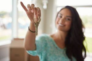 Girl Holding Keys to her new apartment