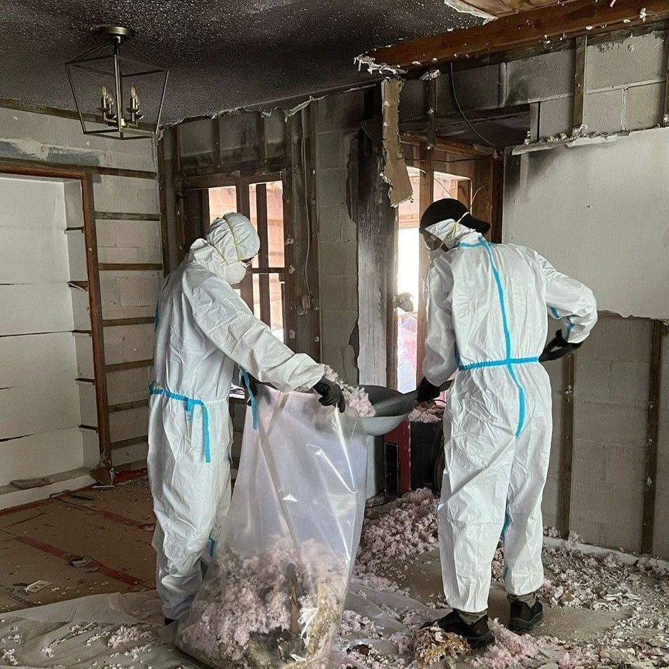 A man is standing in a living room holding a camera.