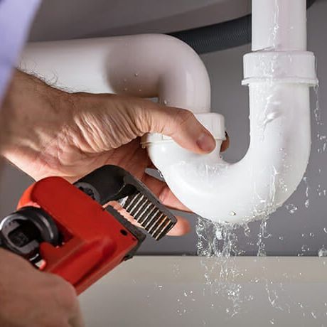 A close up of a faucet in an orange bowl