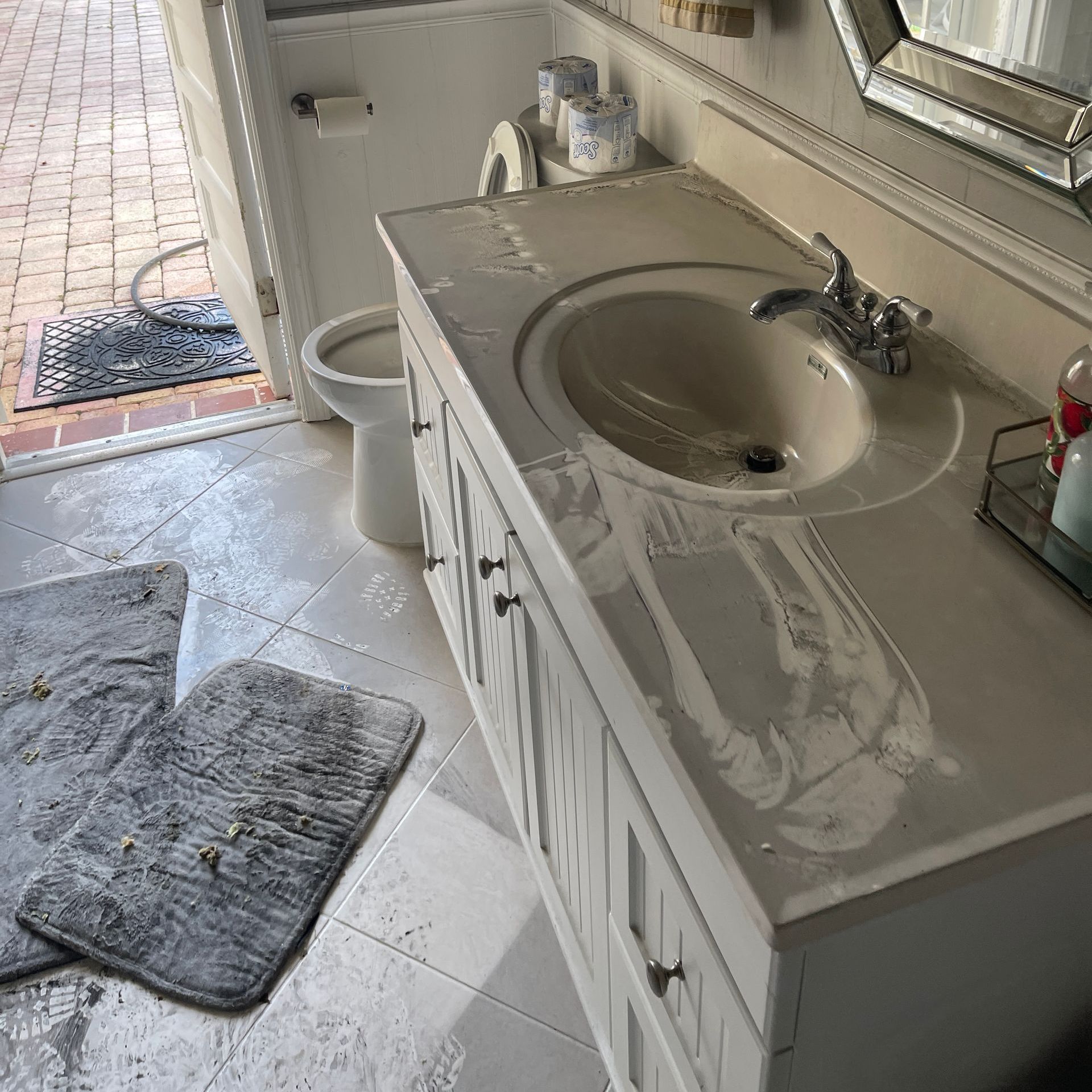 A bathroom with a sink , toilet and mirror