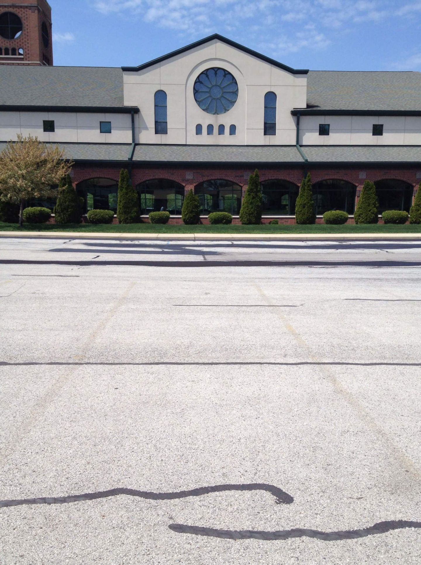 Commercial Building Exterior With Highway — Schereville, IN — Ristich Asphalt Paving Inc