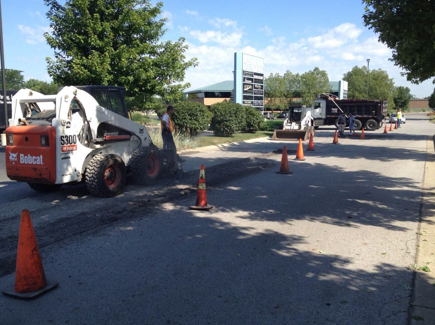 Pavement Trucks And Workers On The Road — Schereville, IN — Ristich Asphalt Paving Inc