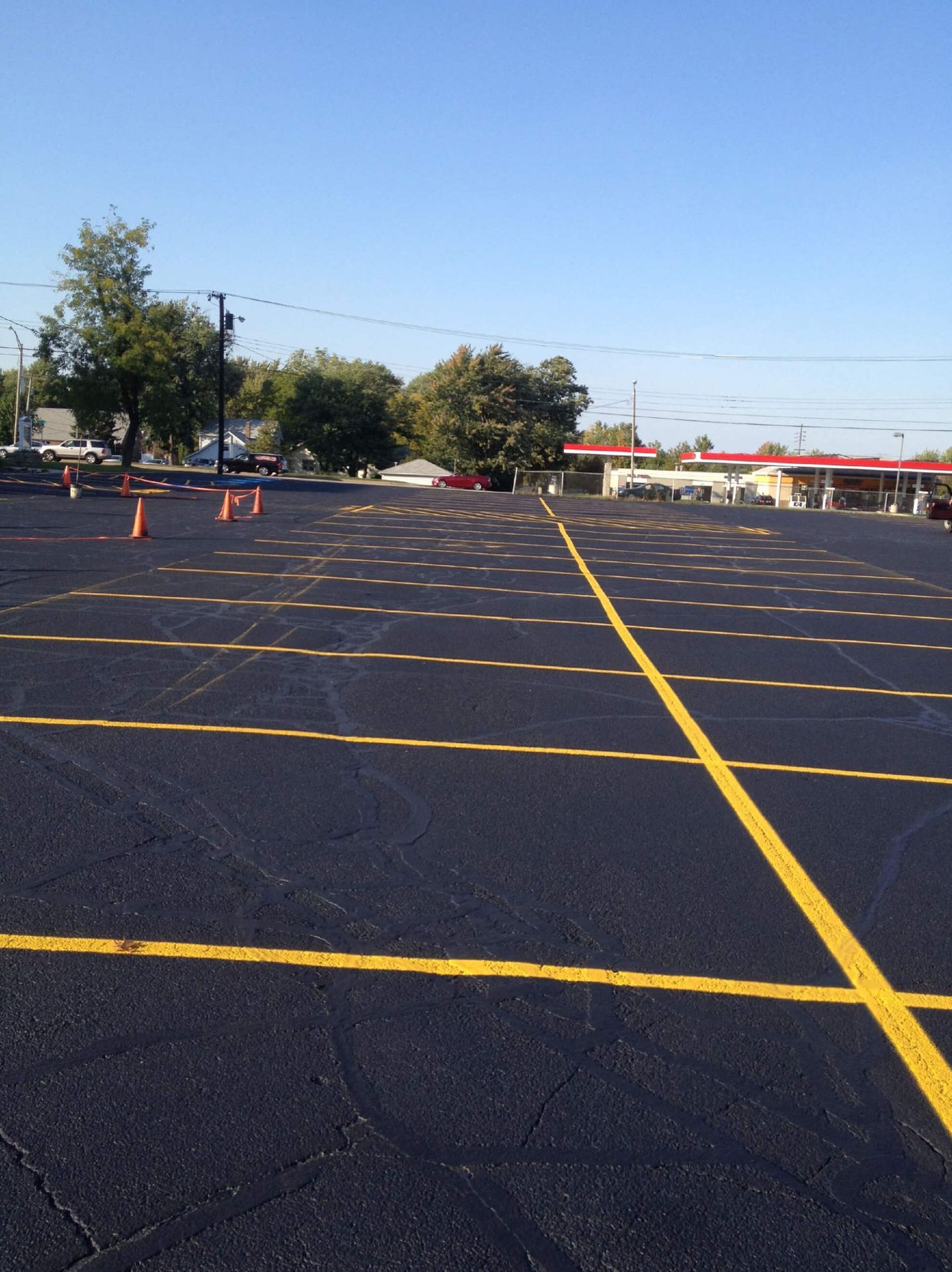 Parking Lot Crack Fillings With Yellow Lines — Schereville, IN — Ristich Asphalt Paving Inc