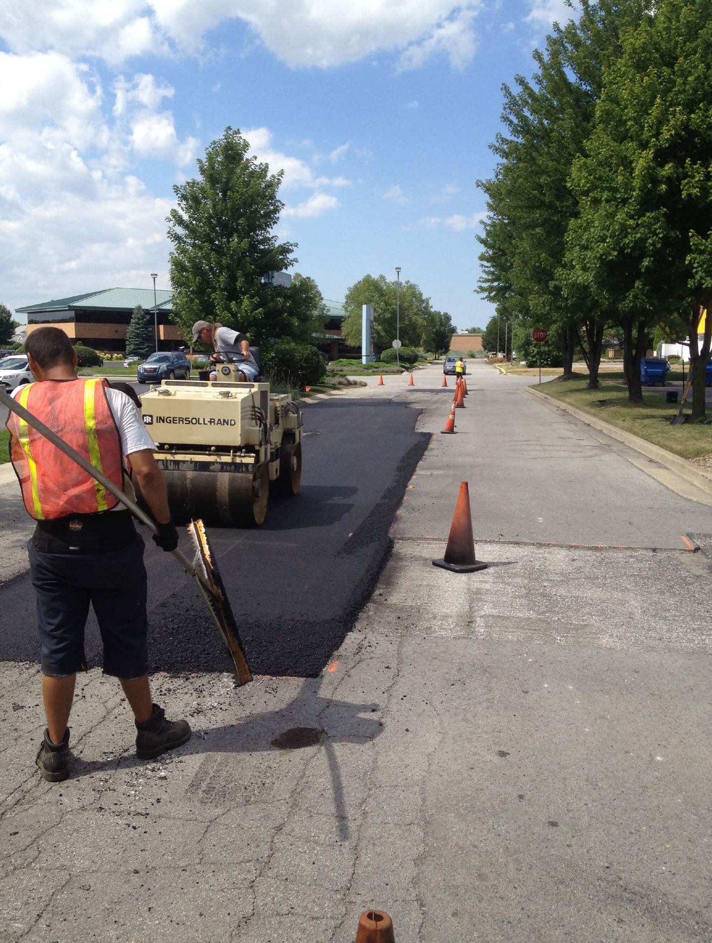Industrial Pavement Truck Laying Fresh Asphalt — Schereville, IN — Ristich Asphalt Paving Inc