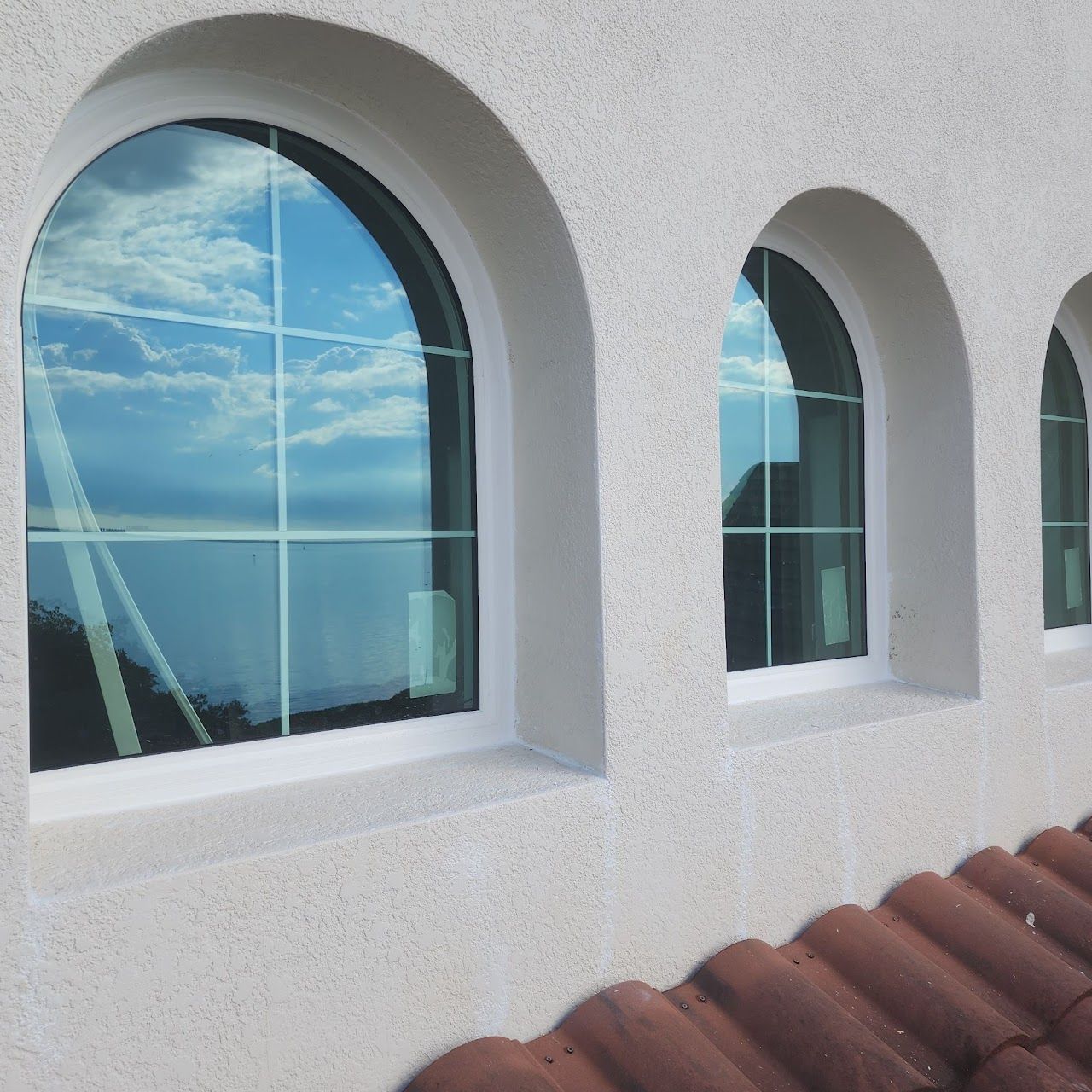 Storm windows installed on stucco exterior – energy-efficient and impact-resistant