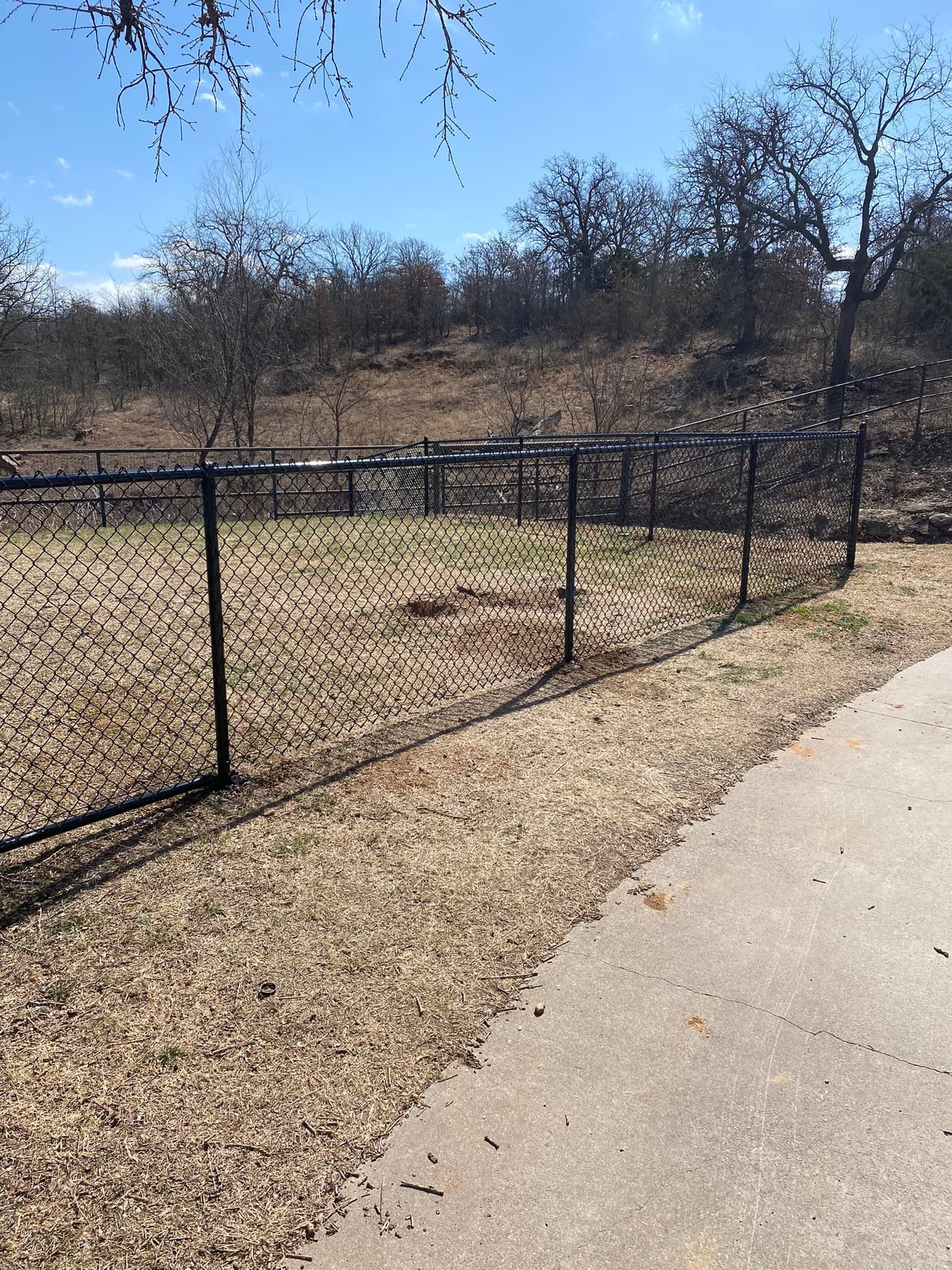 There is a chain link fence along the side of the road.