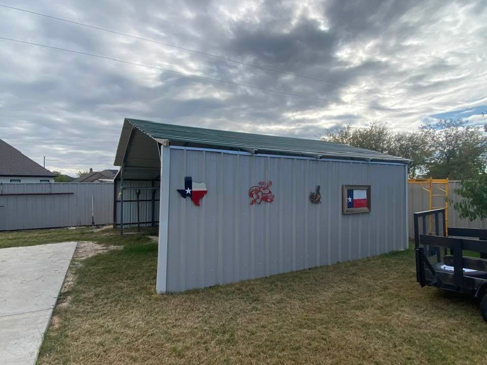 A metal shed with a green roof and a texas flag on the side of it.