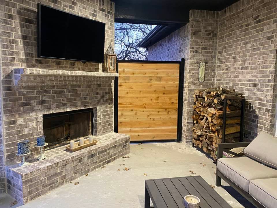 A living room with a fireplace , couch , table and television.