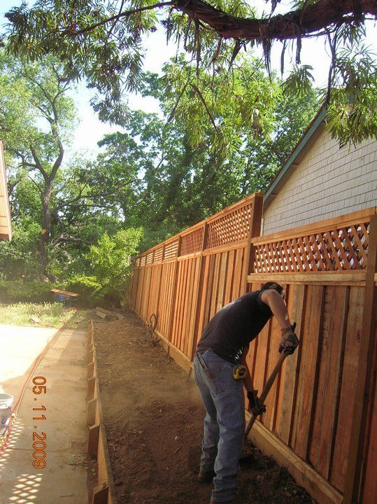 A man is working on a wooden fence and the date is 05 11 2008