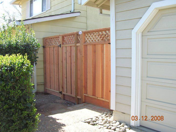 A picture of a house with a wooden fence taken in 2008