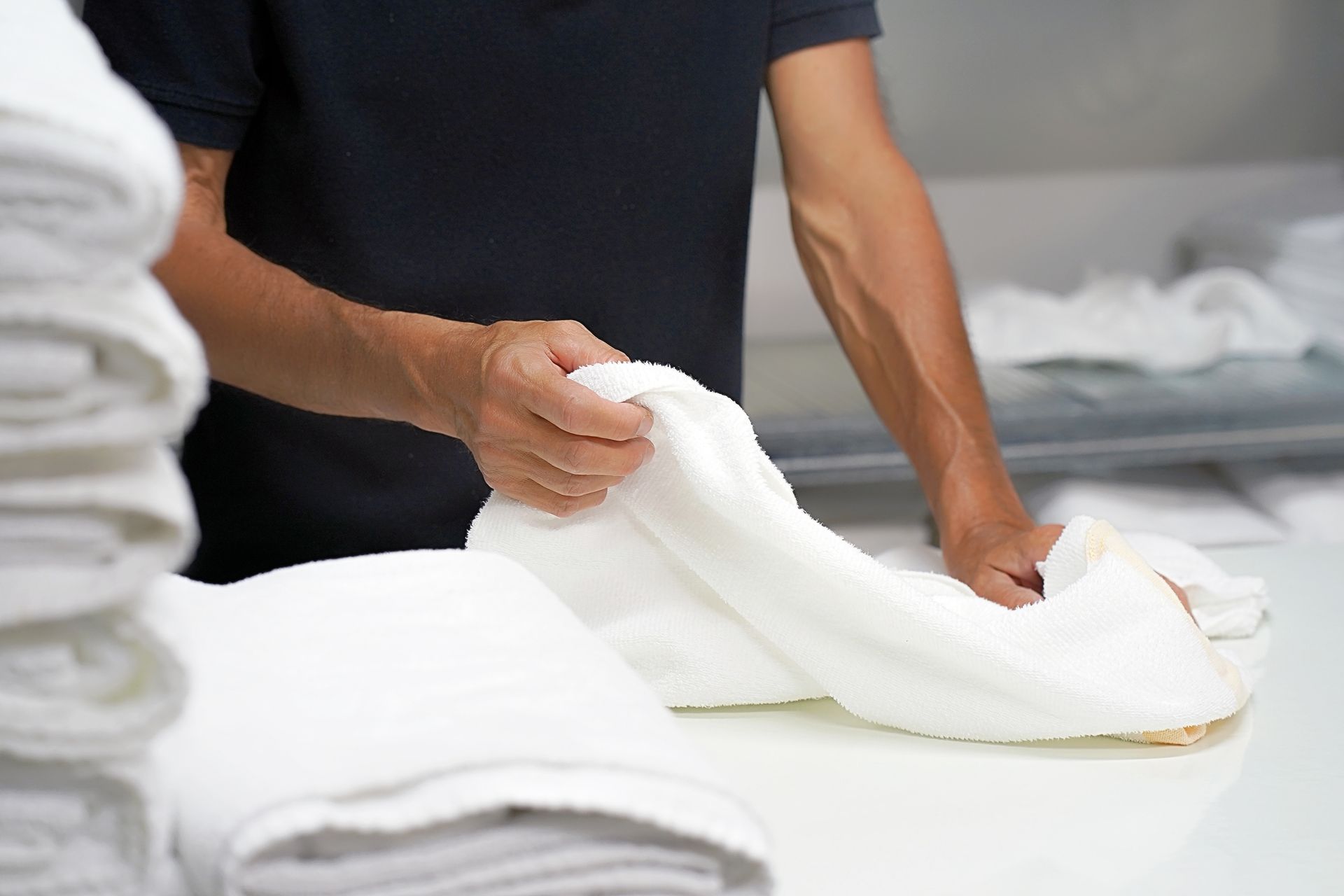 A man folding towels
