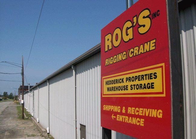 A sign for rog 's rigging and crane warehouse storage