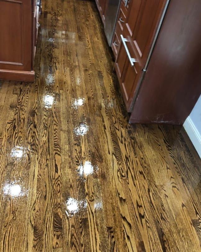 Hardwood floor with dark wood grain and glossy finish.
