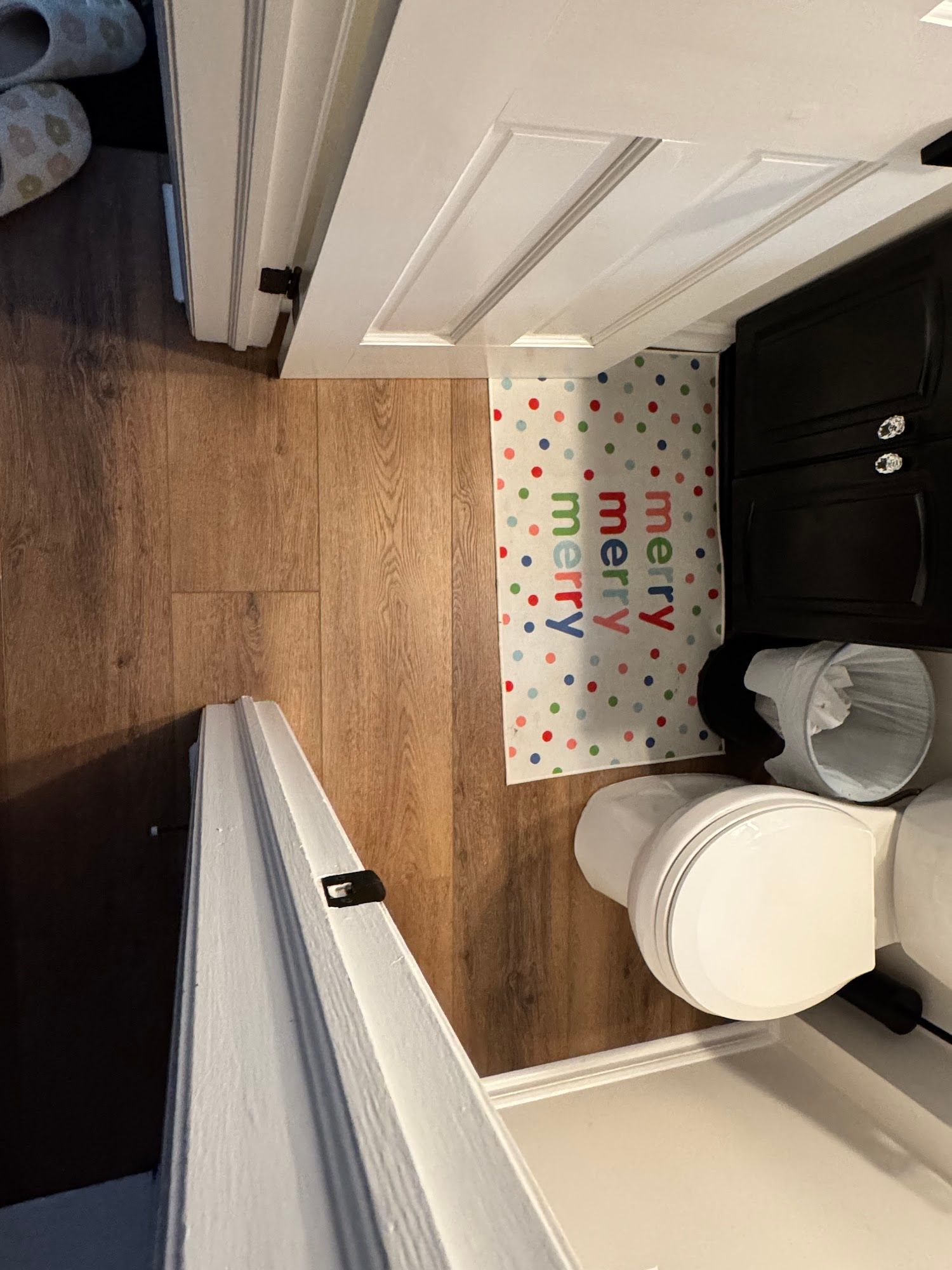 Bathroom with a toilet, cabinet, door, and a 