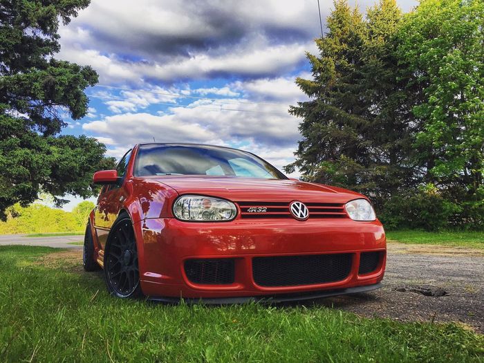 Red Volkswagen GTI Posing On A Scenic Driveway With Blue Sky | Norgren's Auto Center
