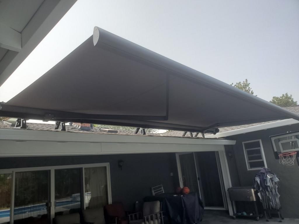 A large awning is covering the roof of a house.