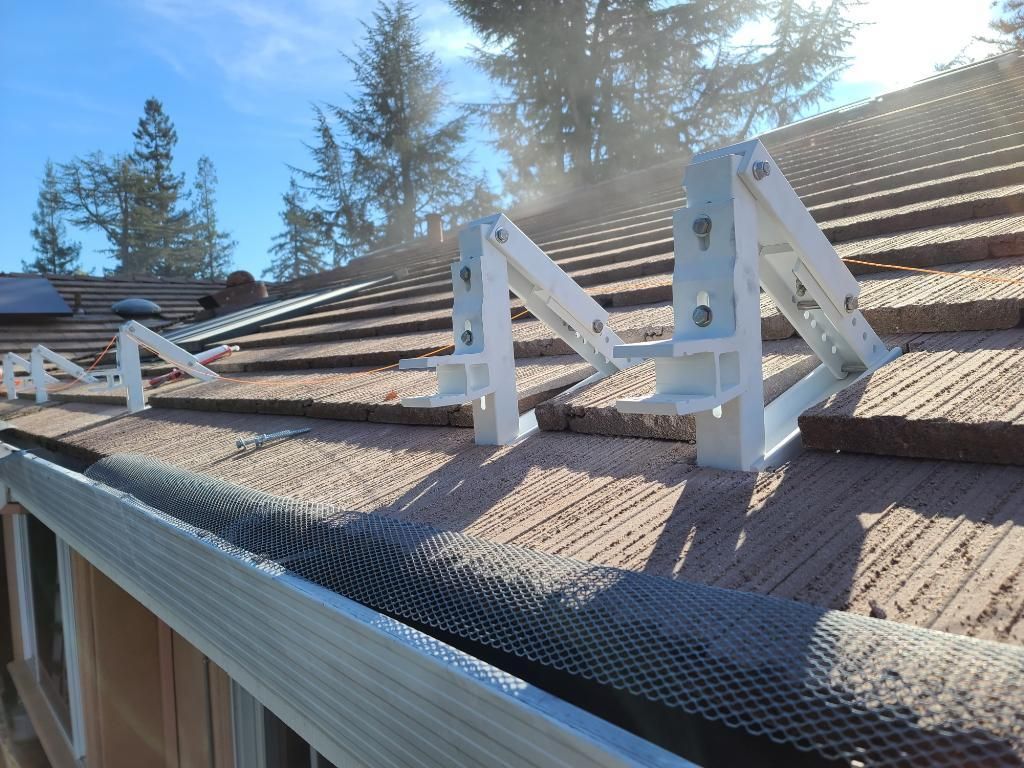 A roof with a gutter and a few brackets on it