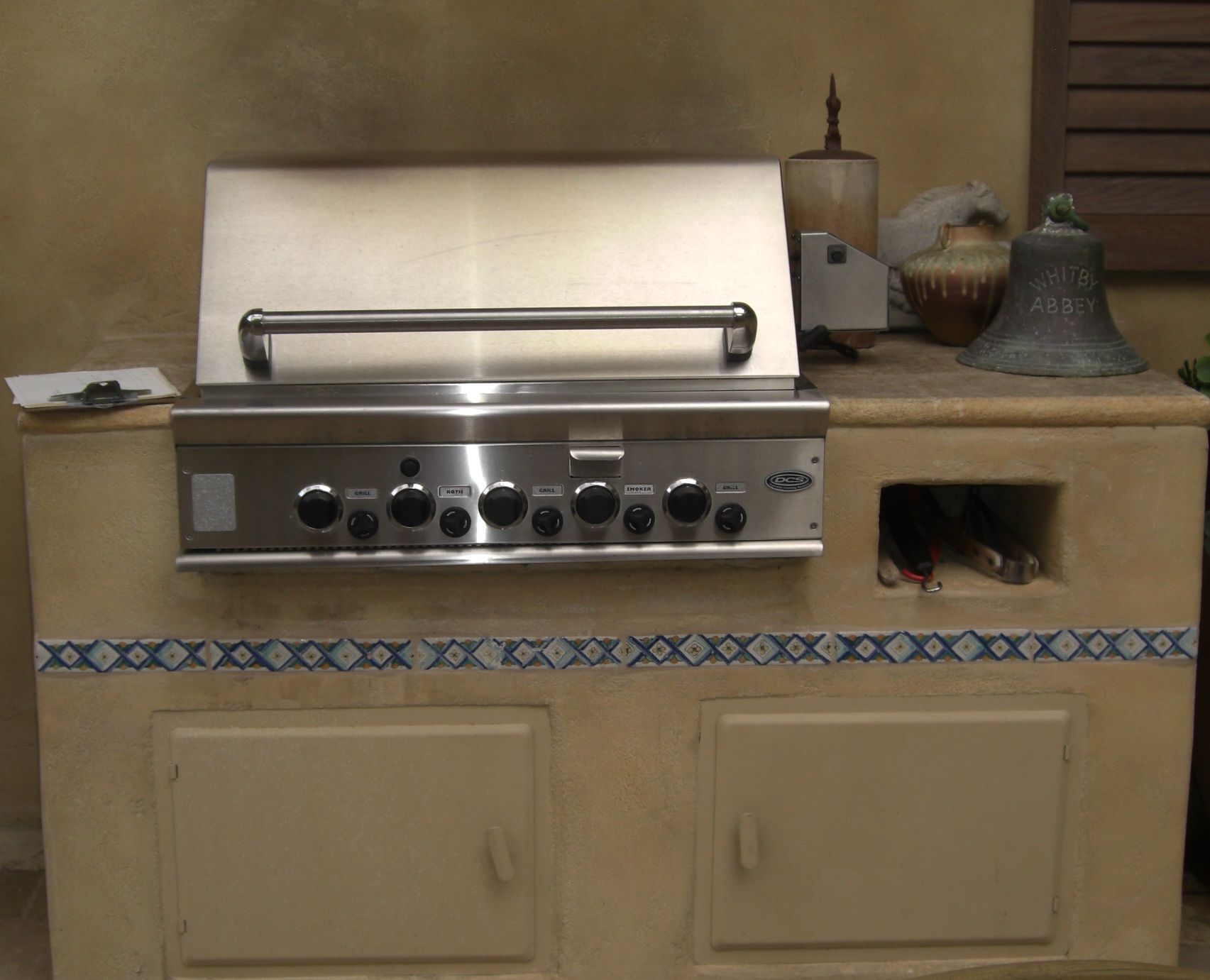A red awning is hanging from the side of a building